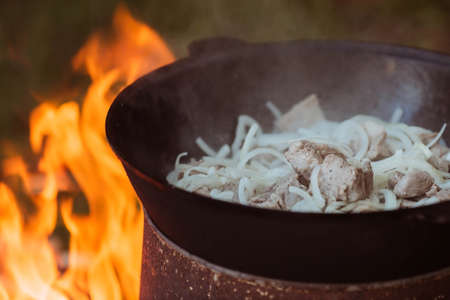 Recipe for traditional oriental pilaf in a cauldron in nature. Cooking. recipes. Step by step photo instructions for cooking pilaf.の写真素材