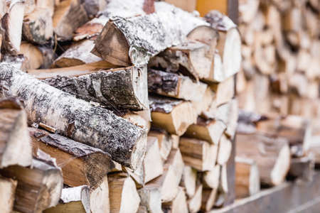 Heating season without gas. It's warm in the house. A stack of firewood for heating the house. The trees were cut down and split into firewood for use as fuel for fireplaces and stの写真素材