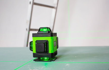 Construction and finishing works indoors. Laser construction level with green beams on the wall....