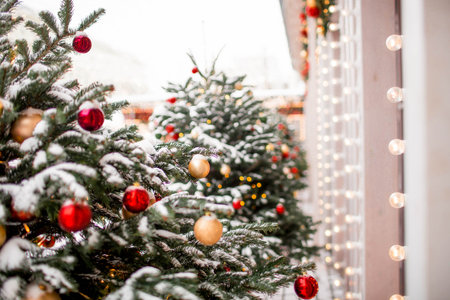 Christmas decoration of the streets. in classic red and green tones. Beautiful landscape festives in the city. Decorated Christmas trees.の写真素材
