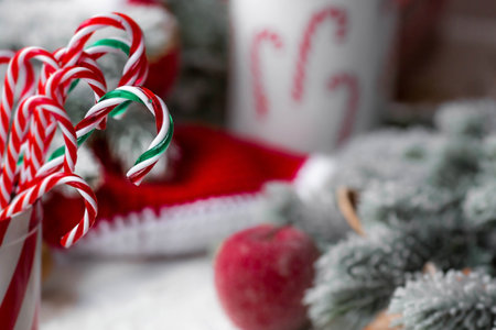Happy New Year 2023. Banner. Striped candy sticks in a jar, a place to copy text. Lollipop cane. A greeting card for Christmas. A concept for a candy store.の写真素材