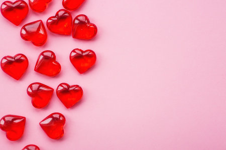holiday card. Little red hearts on a fashionable pink background. Space for an inscription....