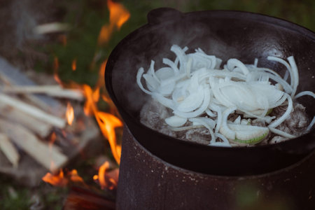 Recipe for traditional oriental pilaf in a cauldron in nature. Cooking. recipes. Step by step photo instructions for cooking pilaf.の写真素材