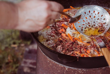 Recipe for traditional oriental pilaf in a cauldron in nature. Cooking. recipes. Step by step photo...
