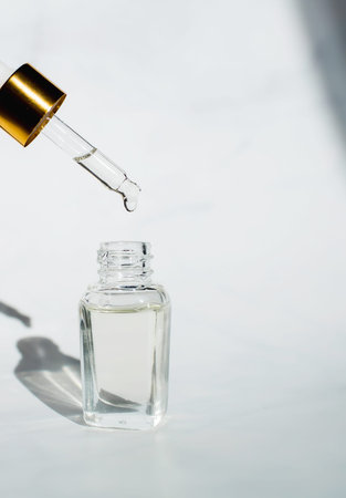 close-up. The concept of cosmetology and beauty. Dropper Glass Bottle Mock-Up. ?osmetic pipette on white background.の写真素材