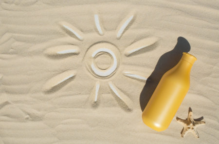 Sun protection factor and starfish on the sand. A bottle of sunscreen. The concept of sea recreation...