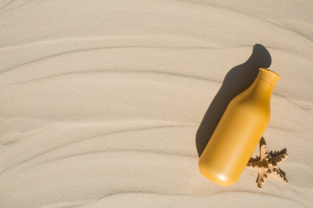 Sun protection factor and starfish on the sand. A bottle of sunscreen. The concept of sea recreation and skin care.の写真素材