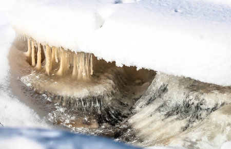 Winter landscape of Ruskeala Park. Ruskeala waterfalls under the snow at sunset. The frozen Tohmajoki Waterfall. beautiful winter landscape. Russia, Republic of Karelia.の写真素材
