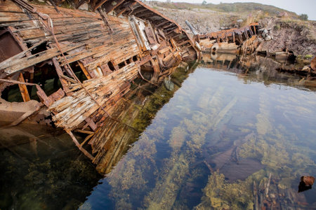 The wreckage of old ships off the coast of the Barents Sea. Wrecked, abandoned by the fleet. Russia, Teriberka village, August 2017の写真素材
