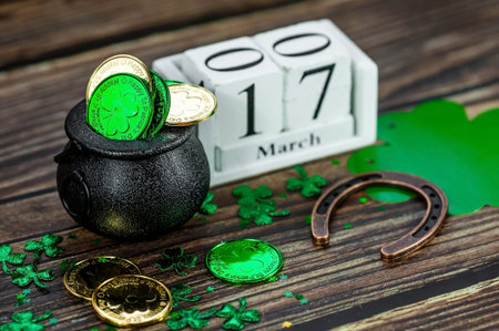 Vintage white calendar for St. Patrick's Day, March 17, with a lucky horseshoe and a pot of gold on...