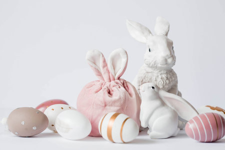 A beautiful postcard. Banner. The concept of a bright Easter holiday. White rabbits and Easter eggs...