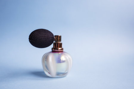 Perfume bottle with an empty label on a blue background.の写真素材