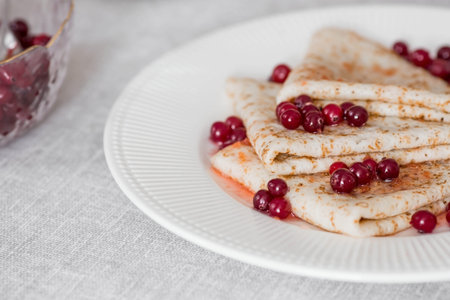 Russian traditions. Russian holiday Maslenitsa. Still life with a cup of tea, a stack of pancakes...