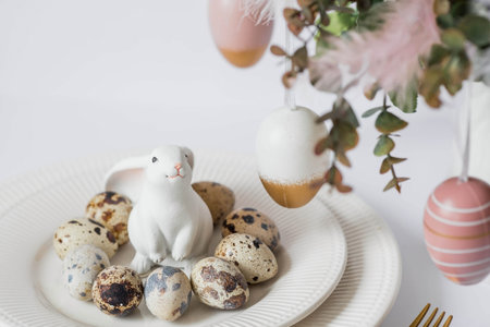 Banner. The concept of a bright Easter holiday. A bouquet of flowers with feathers, white rabbits...