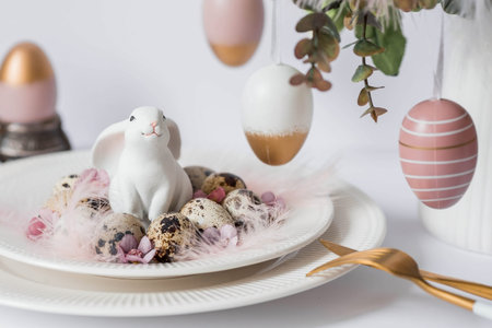 Banner. The concept of a bright Easter holiday. A bouquet of flowers with feathers, white rabbits...