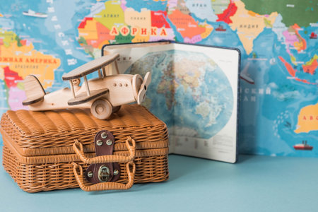 Tourism. A model of a vintage air plane and a suitcase on the background of a world map. The concept of travel, adventure and discovery.の写真素材