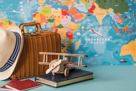 Tourism. A model of a vintage air plane, a suitcase and a Russian passport on the background of a world map. The concept of travel, adventure and discovery.の写真素材