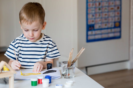 A little boy of 3 years old paints on paper. Children's games for child development. Kindergarten.の写真素材