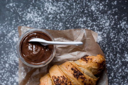 Delicious freshly baked croissants with chocolate on a dark background. french breakfast. Delicious pastries close-up. The context of a bakery with delicious bread. confectionery products.の写真素材