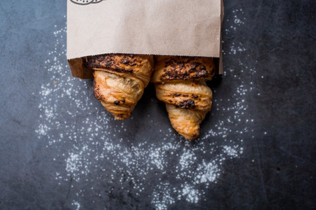 Delicious freshly baked croissants with chocolate on a dark background. french breakfast. Delicious pastries close-up. The context of a bakery with delicious bread. confectionery products.の写真素材