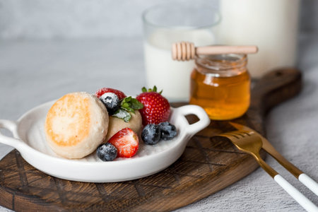 Cottage cheese pancakes, Russian cheesecakes with fresh blueberries, strawberries, honey and mint...