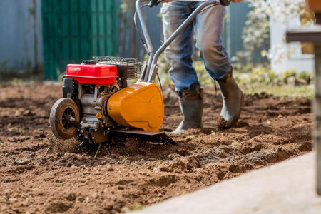 Banner. Man Farmer plows the land with a cultivator. Agricultural machinery: cultivator for tillage...