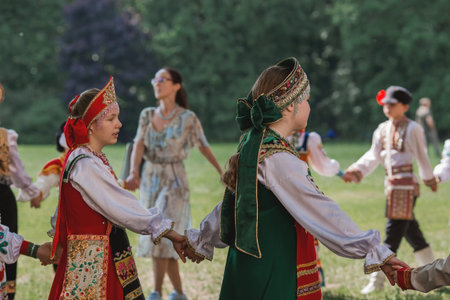 Russian folk traditions. Folk festivals. Children in beautiful Russian traditional outfits sing songs, dance and lead a round dance in Tsaritsyno Park. National Russian clothes. Sundresses and kokoshniks.のeditorial素材