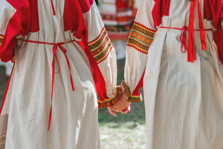 Russian folk traditions. folk festivals. Children in beautiful Russian traditional outfits hold hands and lead a round dance in Tsaritsyno Park. National Russian clothing. Sundresses and kokoshniks.の写真素材