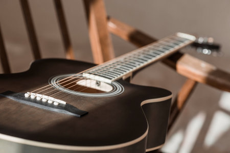 guitar. Guitar chords. Acoustic guitar. music. musical background. An image of an acoustic guitar in a room with a retro armchair. hard light. shadows.の写真素材