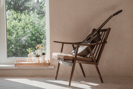 guitar. Guitar chords. Acoustic guitar. music. musical background. An image of an acoustic guitar in a room with a retro armchair. hard light. shadows.の写真素材
