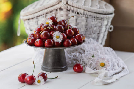 Fruits and berries. summertime. Delicious fresh cherries on a stylish iron tray in retro style on a white table. Space for text.の写真素材