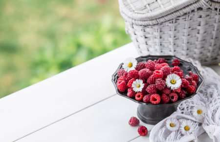 Fruits and berries. summertime. Delicious fresh raspberries on a stylish iron tray in retro style on a white table. Space for text.の写真素材