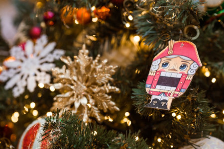 Beautiful decoration festives on the Christmas tree in red and gold tones. Nutcracker. Beautiful Christmas background. New Year's card 2024.の写真素材