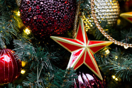 Beautiful decoration festives on the Christmas tree. close-up. Beautiful Christmas background. The concept of decorations and decor for the new year. New Year's card 2024.の写真素材
