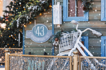 Beautiful holiday decorations. A small house and a retro bike in Gorky Park. Beautiful Christmas background. The concept of decorations and decor for the new year. New Year's card 2024.の写真素材