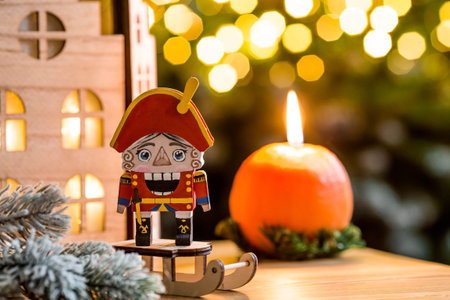 A toy soldier Nutcracker and walnuts on a Christmas background with a garland. Tchaikovsky's ballet....