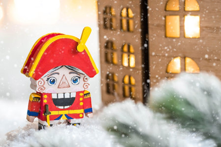 A toy soldier Nutcracker and walnuts on a Christmas background with a garland. Tchaikovsky's ballet. Christmas New Year card 2024.の写真素材