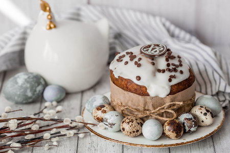 Stylish gray Easter eggs in the colors of marble, concrete, willow branches, Easter chicken and Easter cake on a white wooden background. Coloring eggs for Easter. Environmental friendliness. Naturalness. The feast of bright Easter.の写真素材