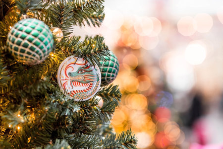 The Year of the Dragon. Beautiful porcelain toys in the form of a dragon on a festive New Year tree in the Gum store in Moscow. Close-up. Chinese New Year 2024.の写真素材