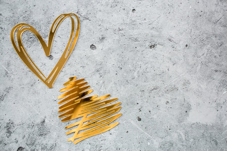 Festive background with abstract golden hearts on a gray concrete background. valentine's day. Love.の写真素材