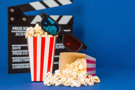 A banner for the film industry. A romantic movie date. A movie camera, 3D glasses, popcorn in...