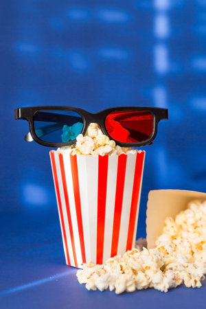 A banner for the film industry. A romantic movie date. A movie camera, 3D glasses, popcorn in...