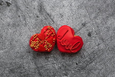 Homemade ginger cookies in the shape of a heart in red icing sugar. Delicious ginger cookies heart...