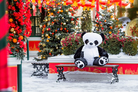 Plush stuffed pandas and Chinese red Christmas lanterns on Tverskaya Street in Moscow. Close-up. The...