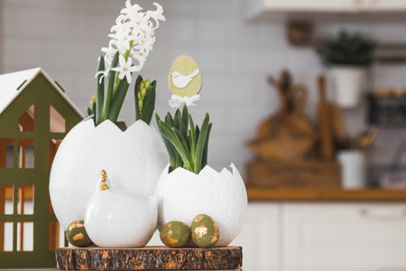 Happy Easter. Spring hyacinth flower in an egg-shaped vase, Easter chicken and eggs with a golden...