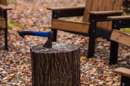 Eco-friendly, stylish barbecue area and wooden chairs for relaxing by the campfire. An ax will be...