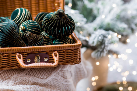 The banner. Stylish paper and velvet Christmas tree toys in Scandinavian style in a wicker suitcase. Green tones. The concept of a stylish new year and Christmas 2025の写真素材