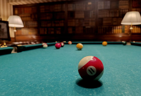 The balls are on the billiard table. We spend time at home playing our favorite sports game.