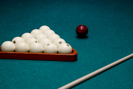 Russian billiards. Red and white balls are lying on a green billiard table. Spending time at home...