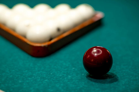 Russian billiards. Red and white balls are lying on a green billiard table. Spending time at home...